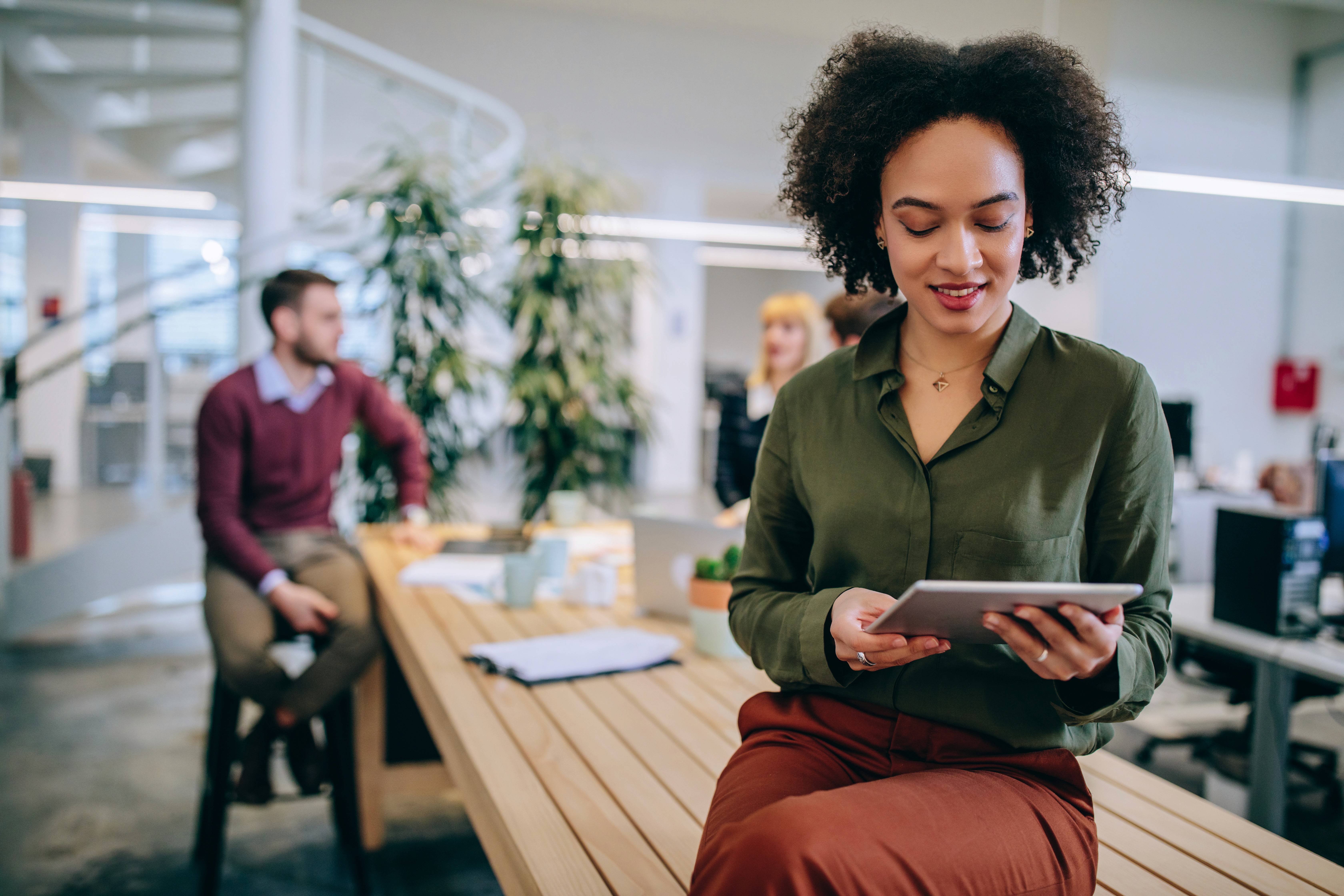 a man and a woman shaking hands in front of a laptop