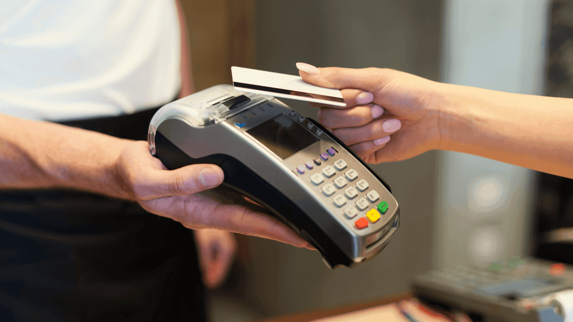 Customer making a contactless payment with a bank card on a POS terminal, representing UK FCA consultation on removing contactless transaction limits.