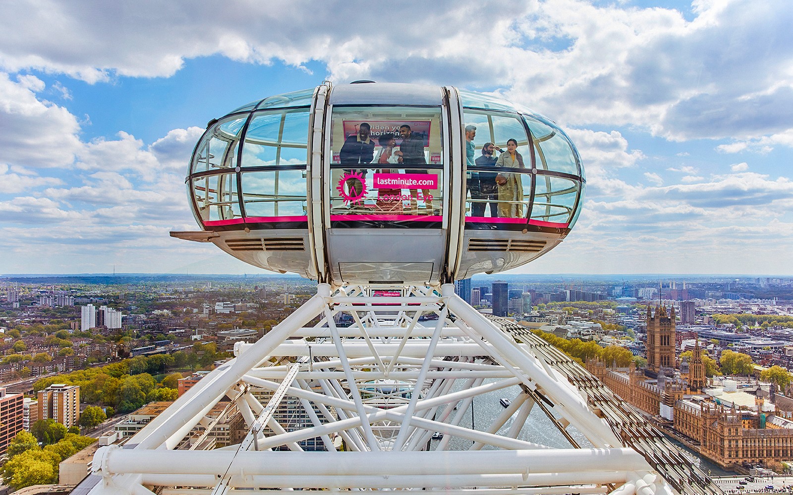London Eye and Thames River Cruise view with Kew Gardens in the background, London.