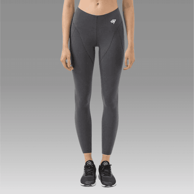 Person wearing gray leggings with a brand logo on a gray background
