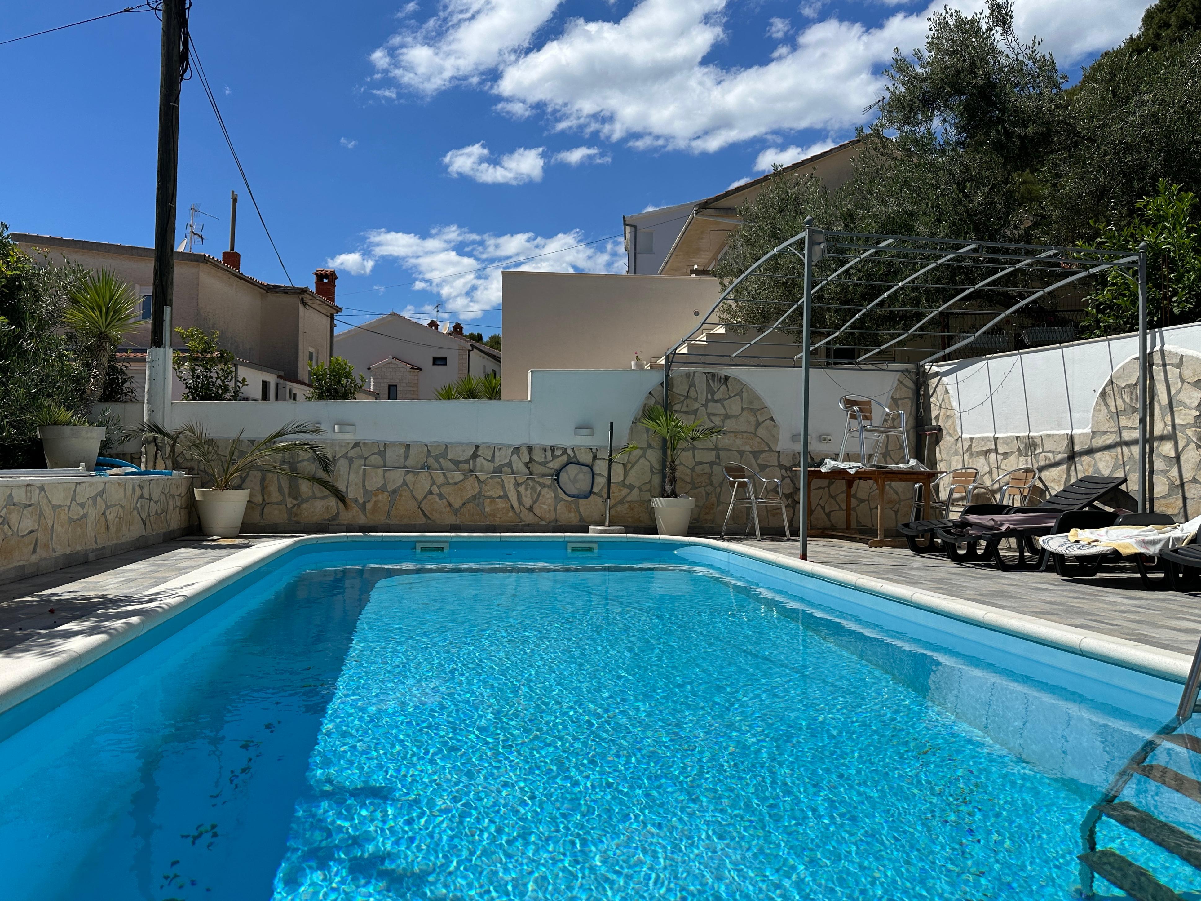 Ornate classic bathroom with claw-foot tub and wood paneling.