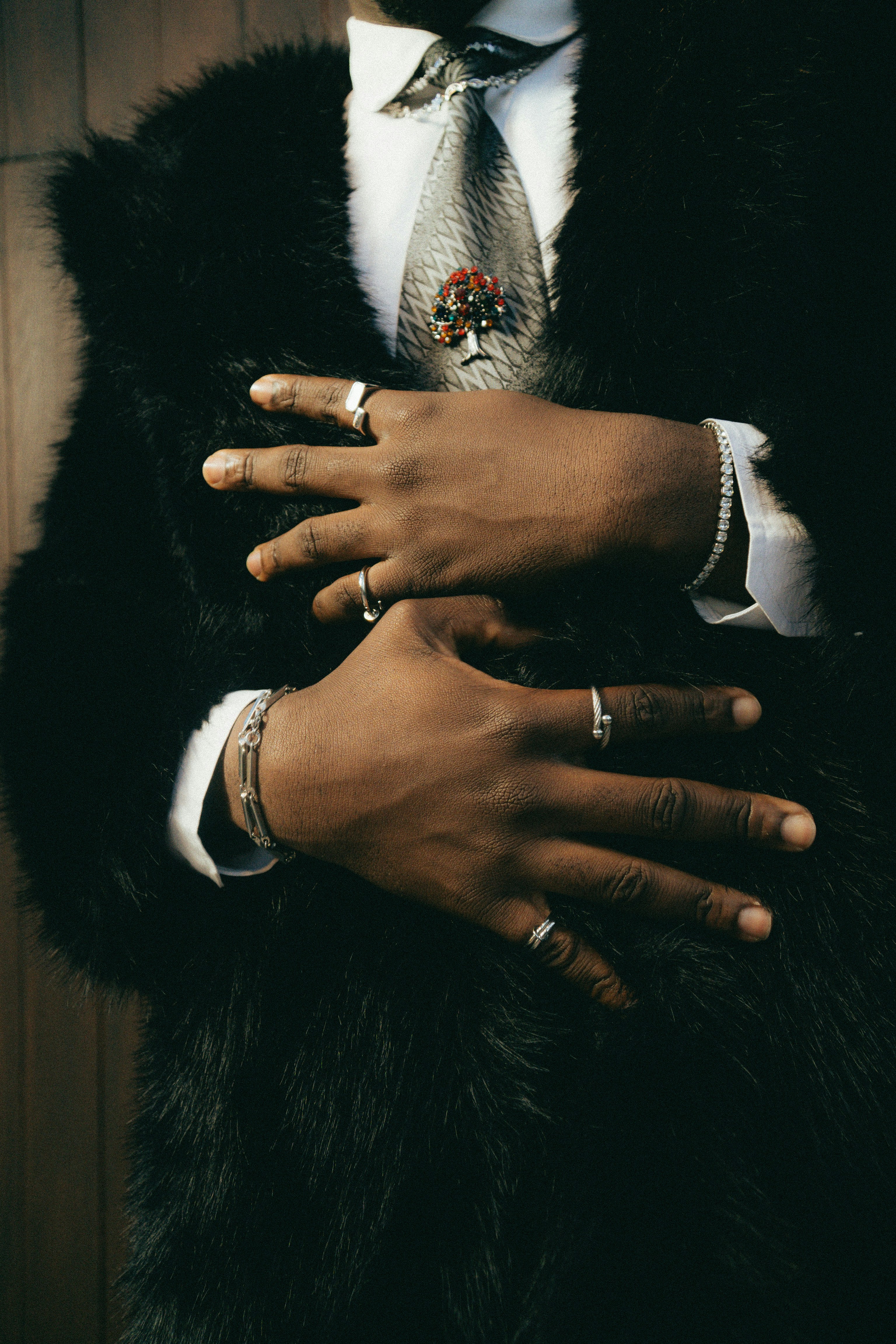 Man in fur coat with jewelry and tie
