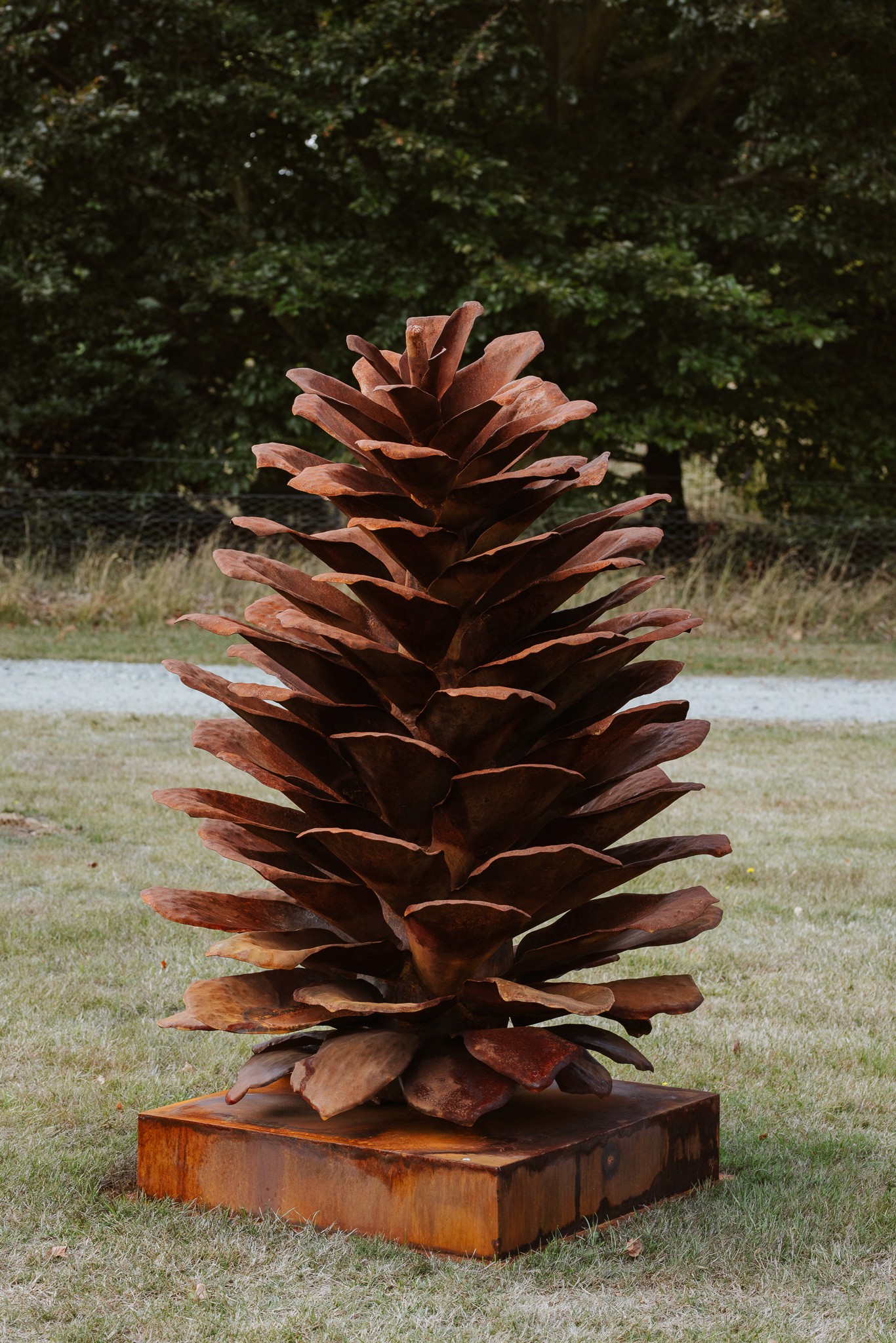 A person stands in a dimly lit art gallery