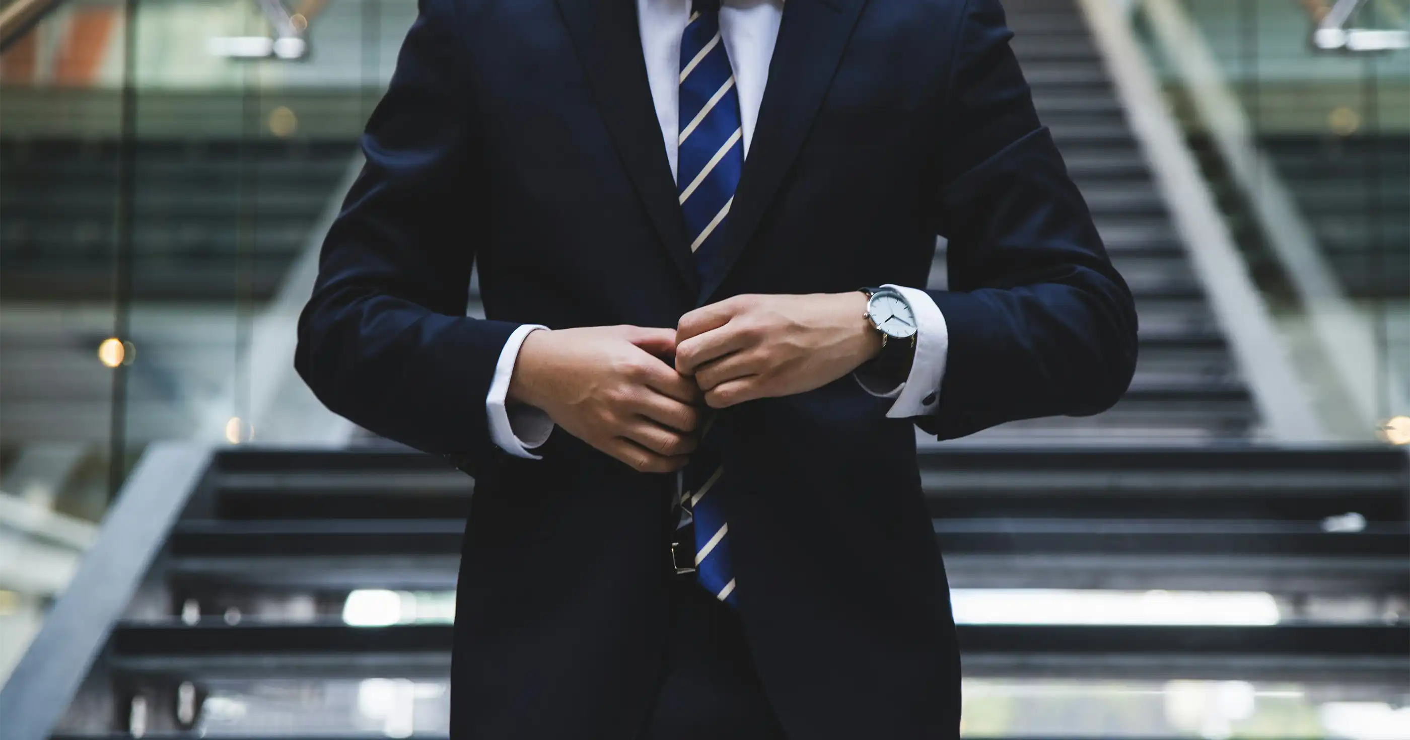 a lawyer in an office buttoning up his suit