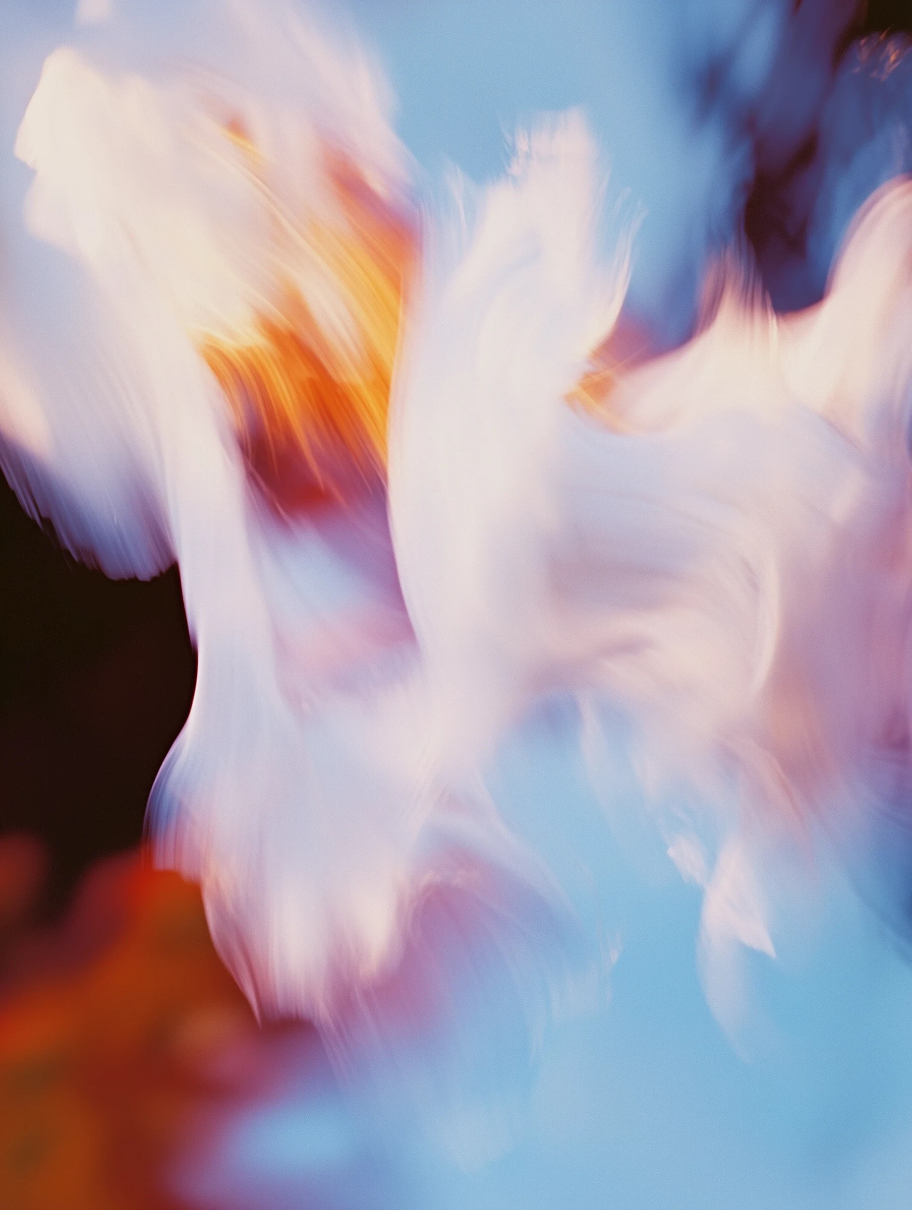 Lumen Table brand visual: motion-blurred white and orange swirls drifting across a sky blue field