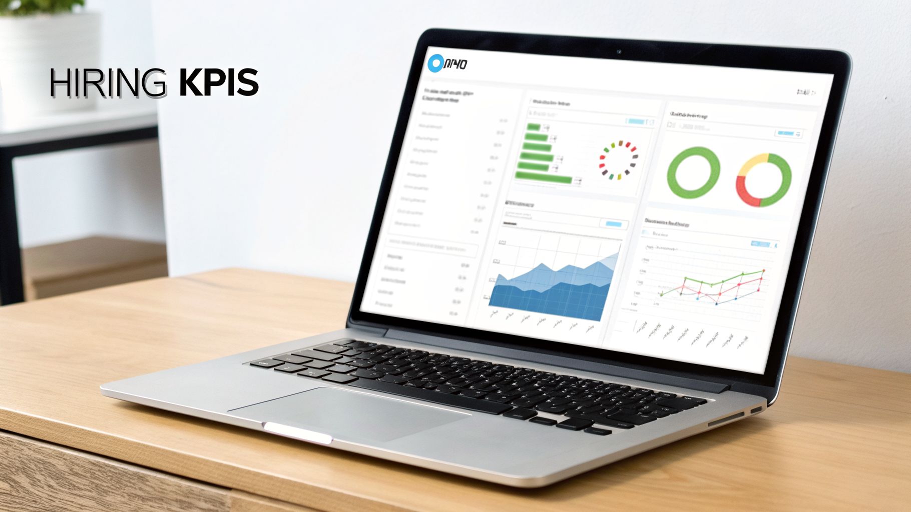 Laptop on a wooden desk displaying a dashboard with hiring KPIs charts and graphs.