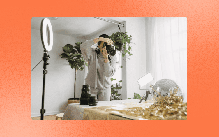 A photographer in a home photo studio taking photos of products.