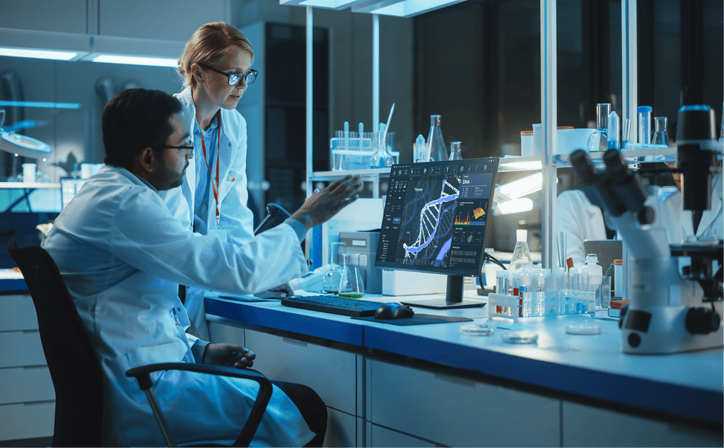 Silhouette of a researcher examining a slide under a microscope with a blue background.