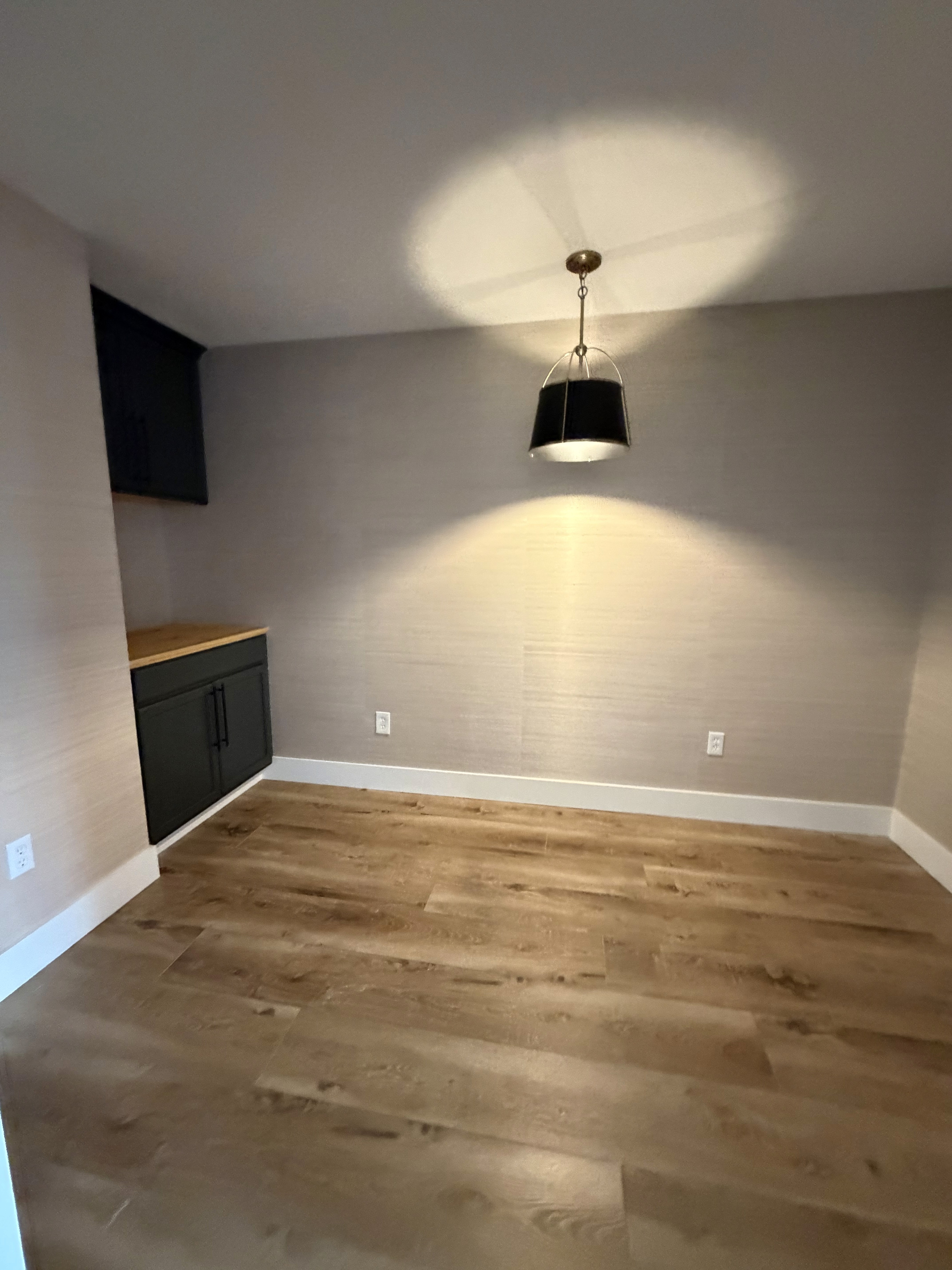 Textured grasscloth wallpaper installation in a luxury suite
