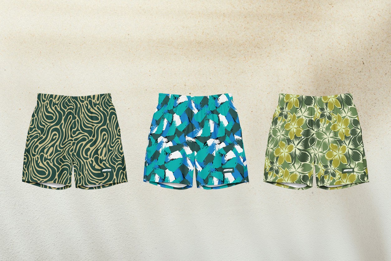 a woman and two men wearing hoodies on the beach