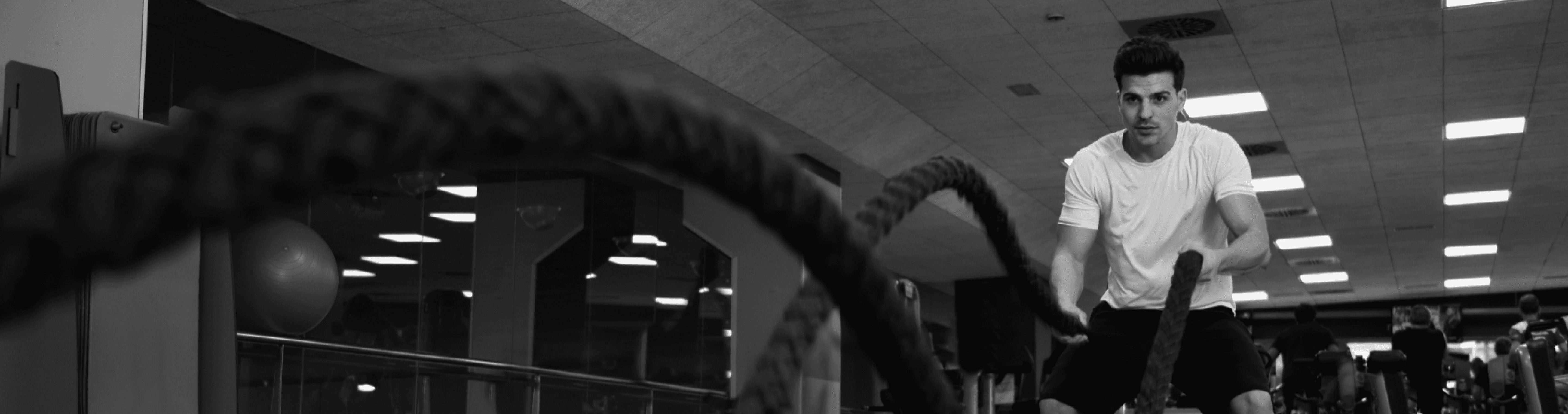 Athletic man exercising with resistance bands