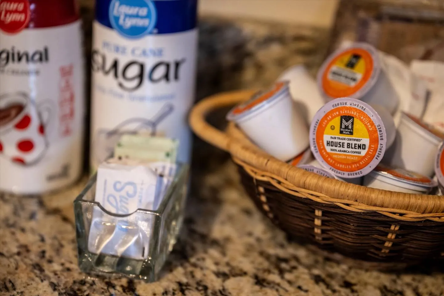 Coffee pods, creamer and sugar set out for guests
