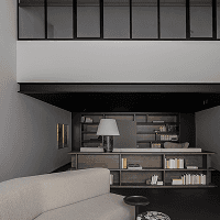 Cozy living room with a sofa and wooden bookshelf