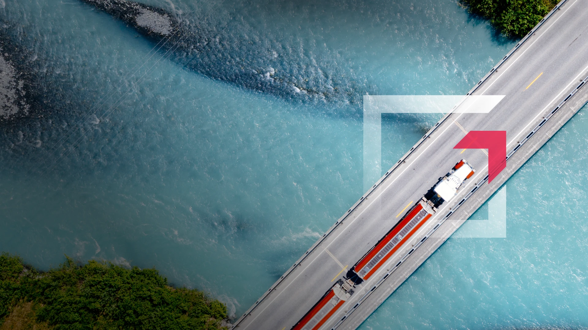 Aerial view of a semi-truck driving across a bridge over blue water representing commercial truck insurance services by GIA Group, LLC, truck insurance agency