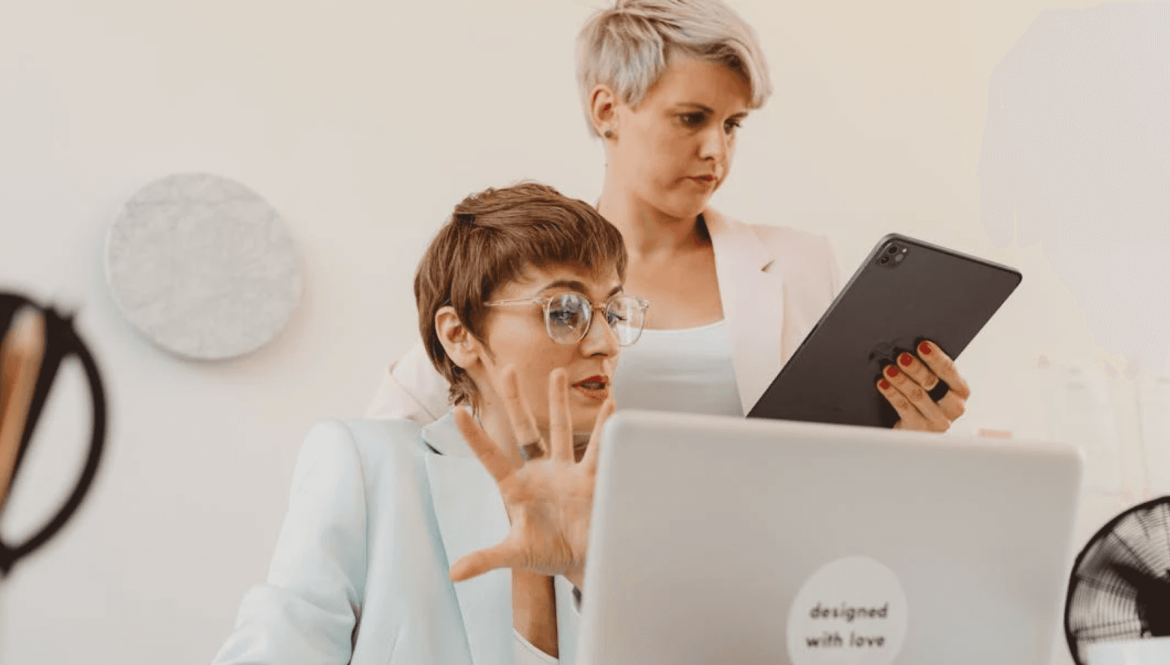 Two woman analyzing and refining their business.