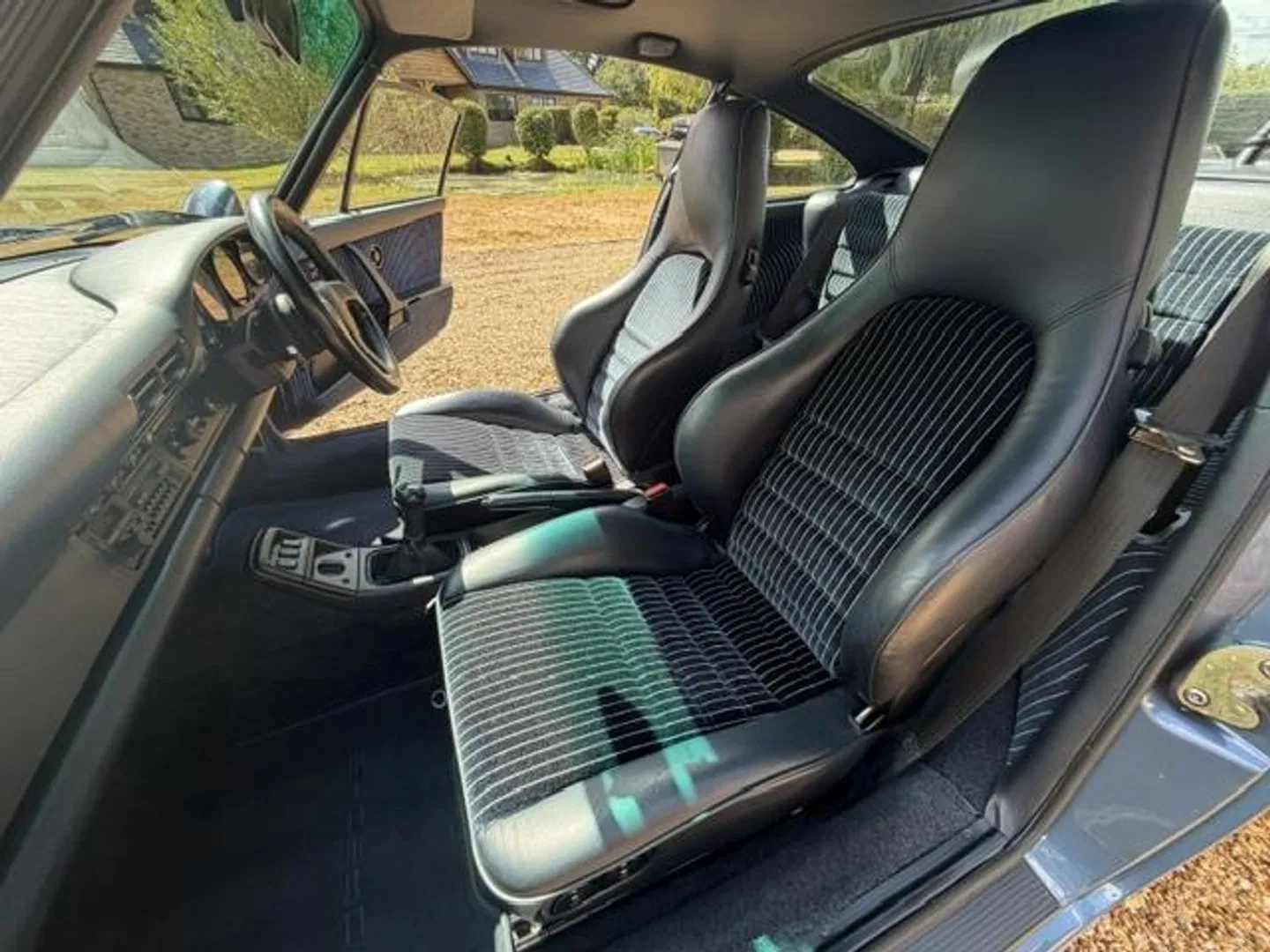 Interior through the passenger door with deep sport seats in pinstripe cloth