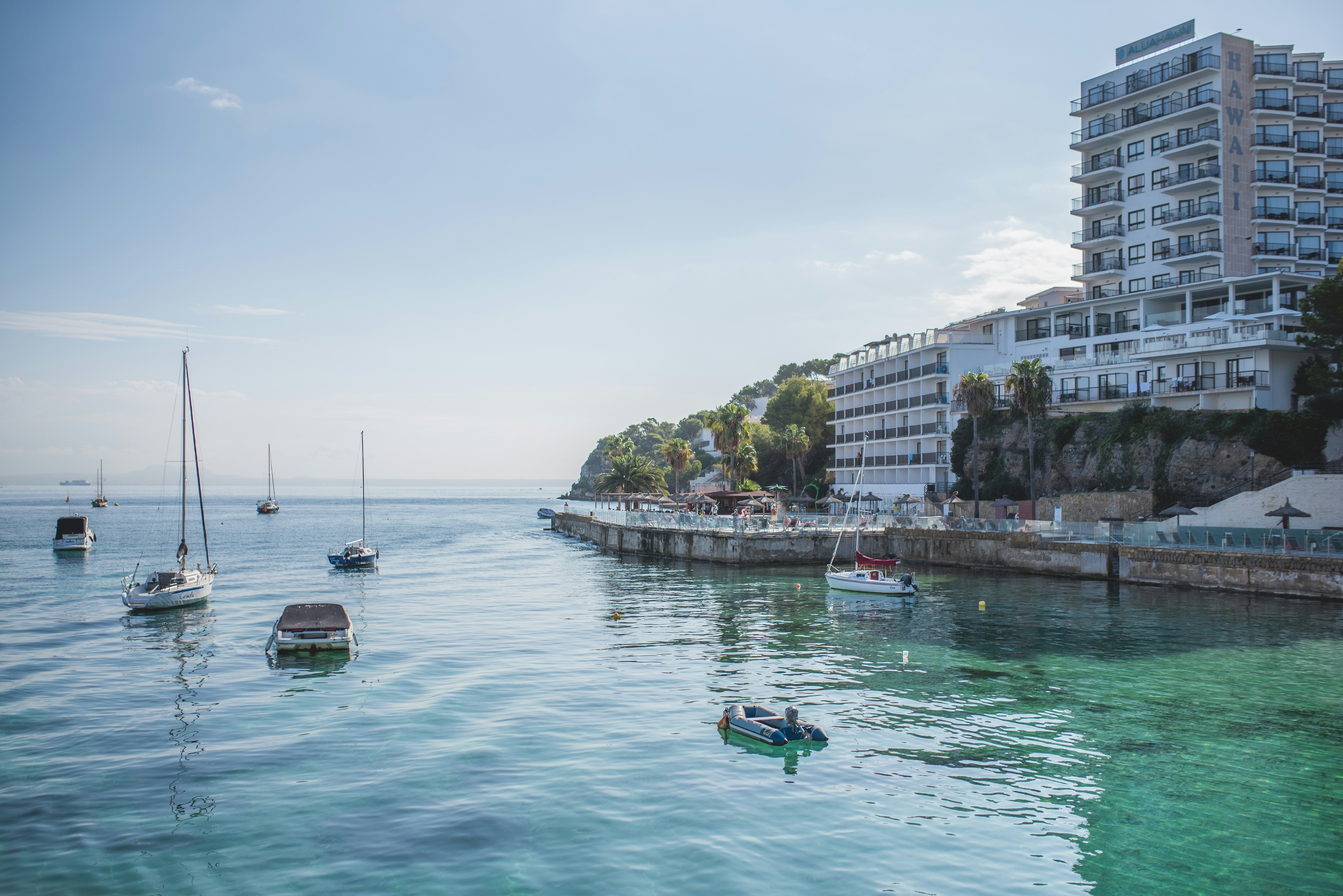 a group of boats floating on top of a body of water