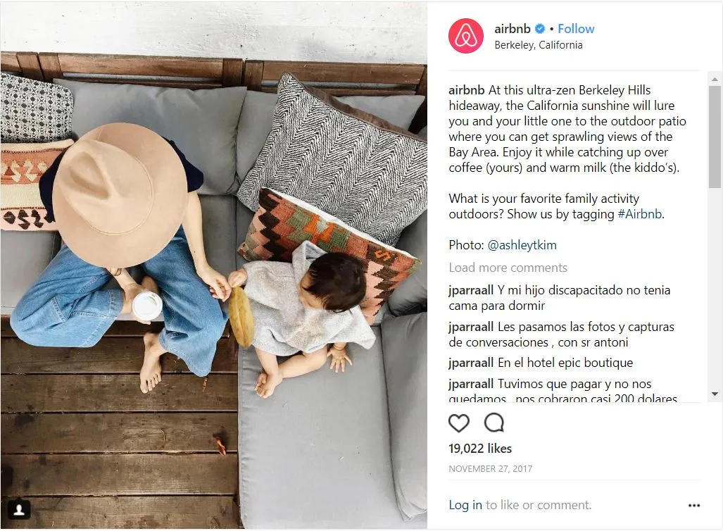 An Instagram post from Airbnb featuring an overhead shot of an adult wearing a hat and a small child relaxing on outdoor cushions, with text describing an "ultra-zen Berkeley Hills hideaway" and asking users about their favorite family outdoor activities.