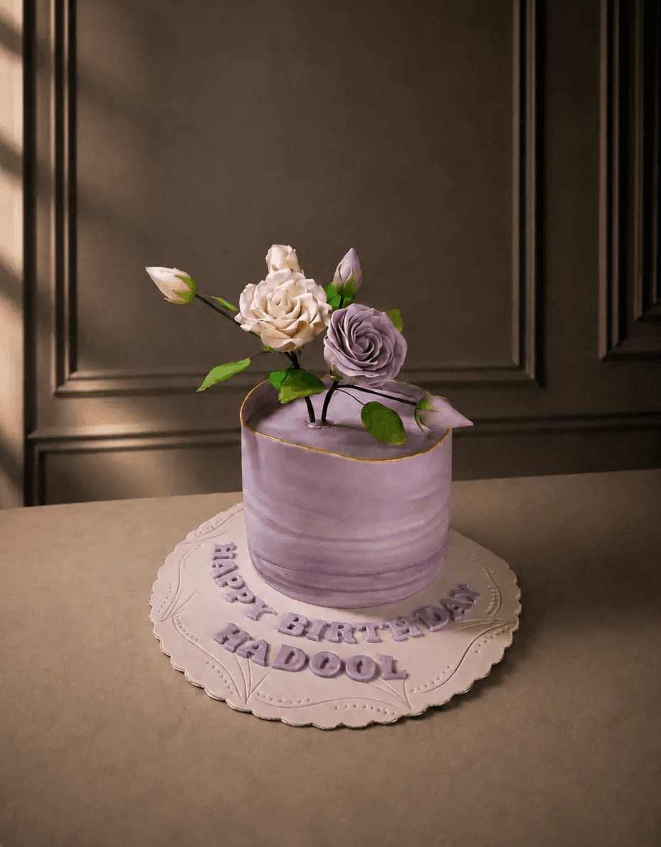 Lavender birthday cake with handcrafted pink and purple sugar flowers by Chef Touq.