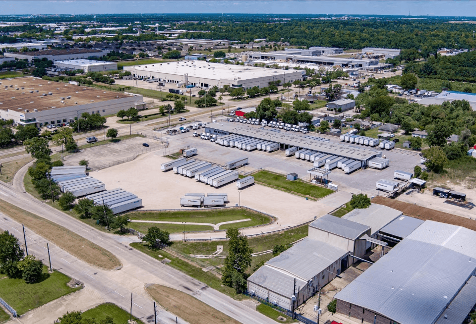Aerial view of a Texas trailer storage yard beside industrial warehouses