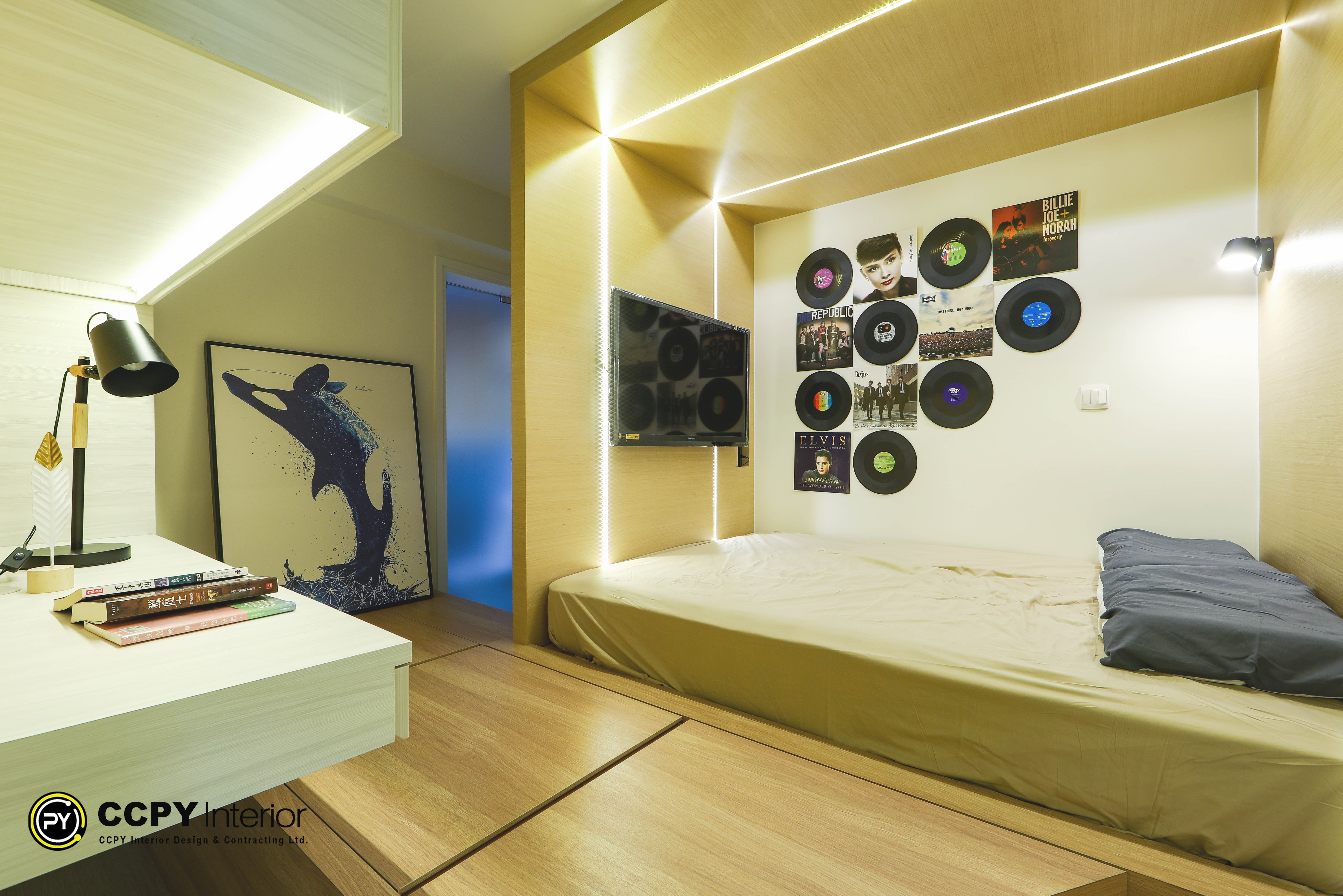Bedroom space with beige bed frame, vinyl record collection wall art, and ambient integrated lighting at Kwan Lok Sun Chuen.