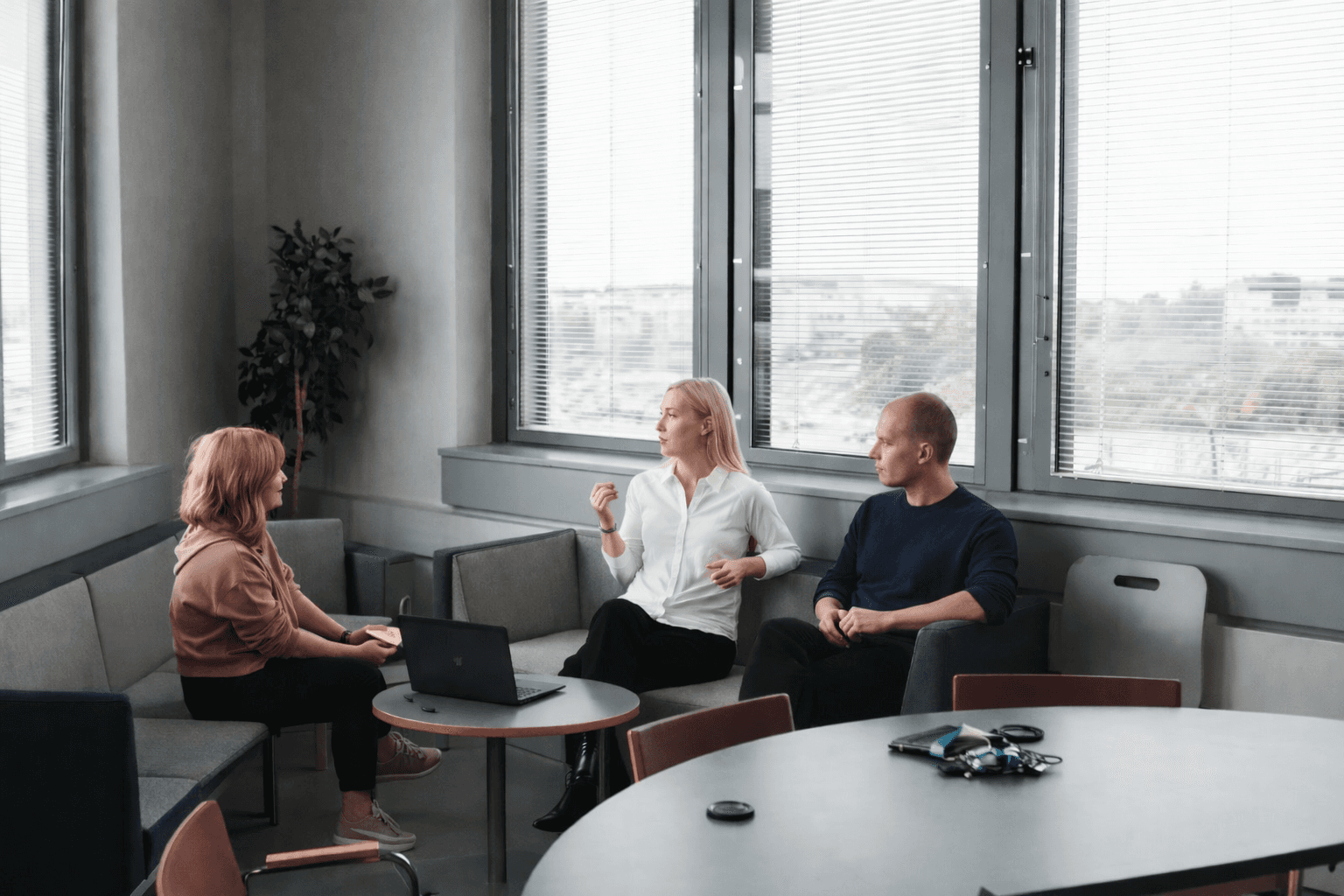 2 women sitting on black sofa
