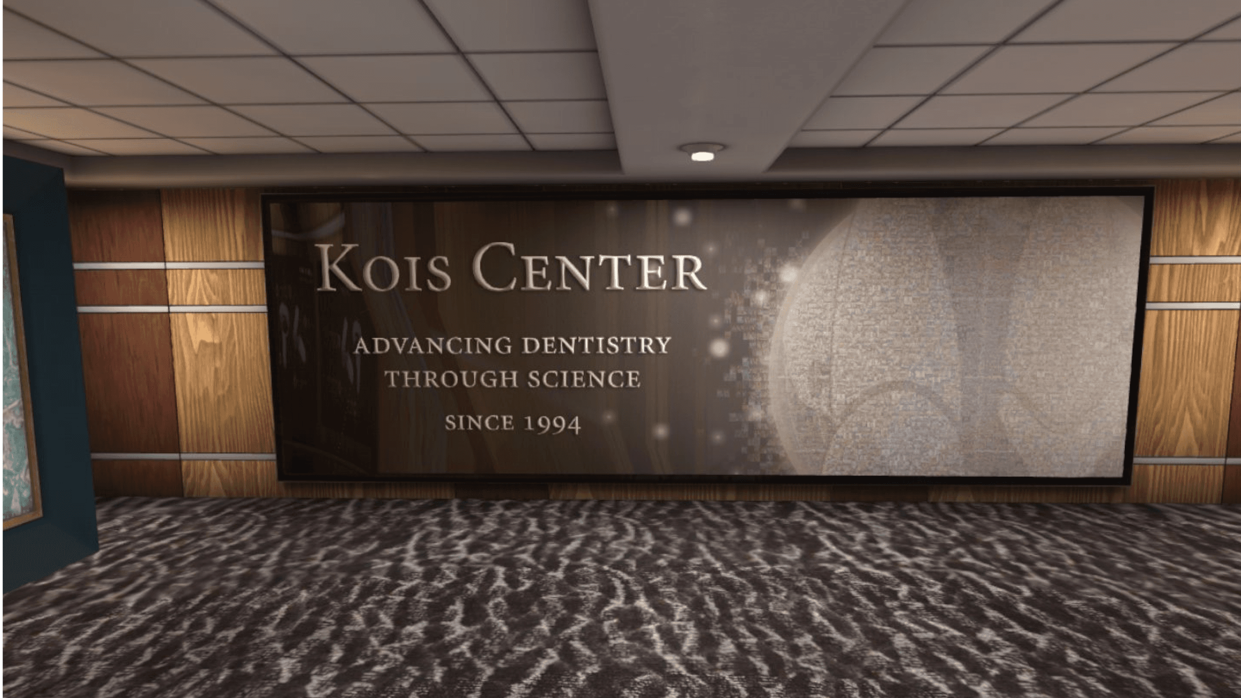 This image shows a virtual educational environment displaying a banner for the Kois Center, a renowned institution in dentistry. The banner reads 'Advancing Dentistry Through Science Since 1994,' symbolizing the use of VR education to provide immersive learning experiences in medical and dental sciences. The virtual setting highlights how Virtual Reality education experiences can replicate real-world learning environments, offering students and professionals access to high-quality educational content in a simulated space. The clean, organized interior reflects the professional approach taken by educational VR platforms, where users can engage with expert knowledge and simulations in specialized fields like dentistry. This virtual reality setup emphasizes the role of virtual reality education in transforming how learners access and interact with advanced scientific and medical knowledge.