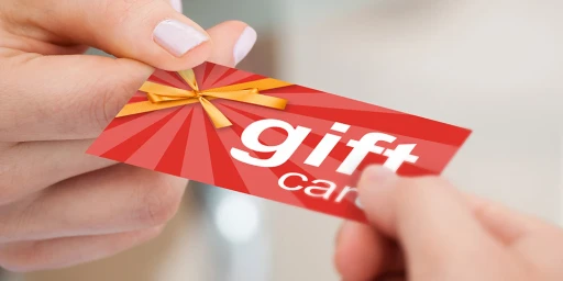 Person Hand Giving Gift Card To Another Person