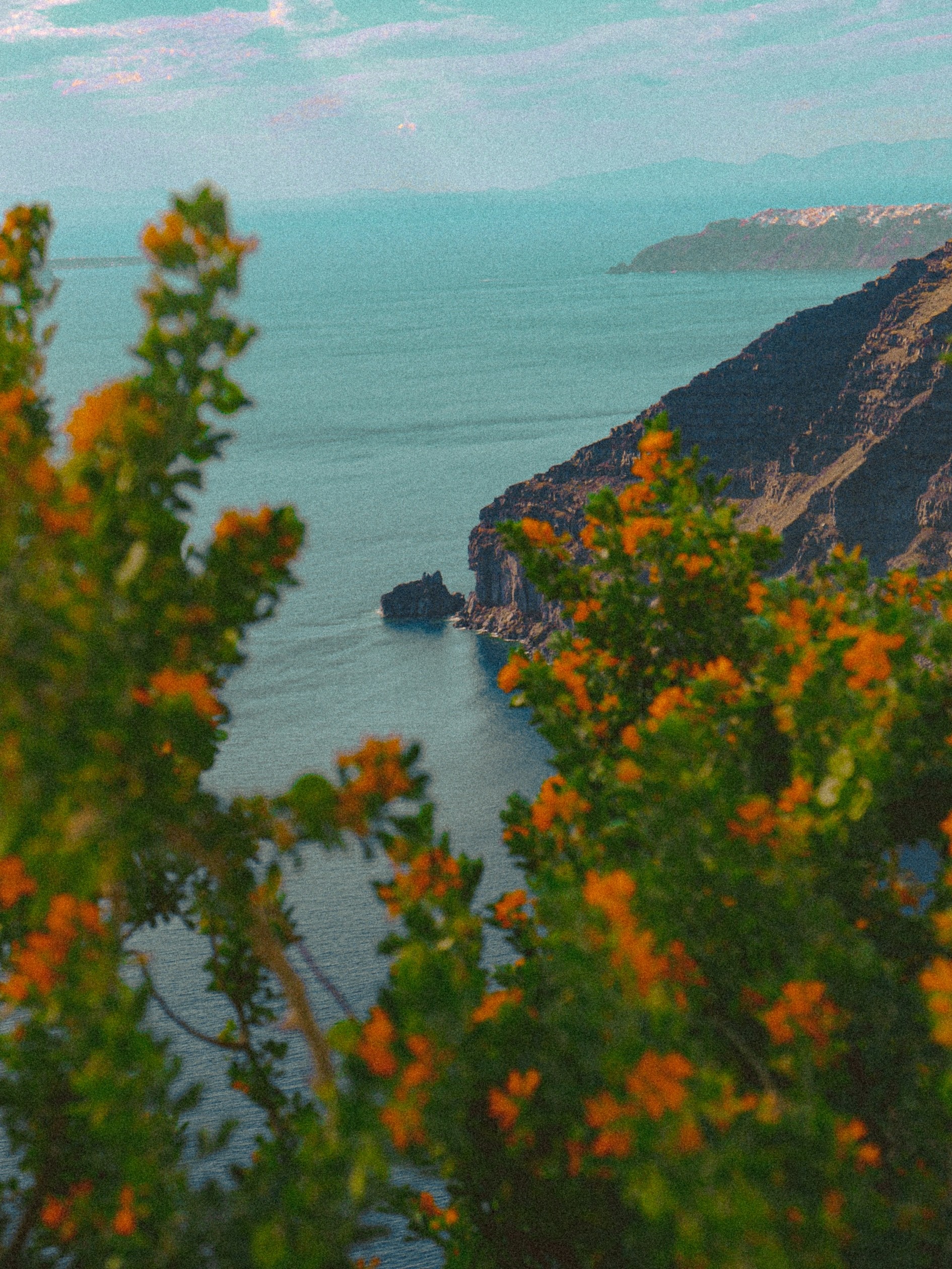 Two islands in the ocean, one is distant and the other is near.