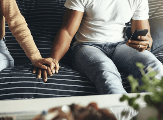 Partners holding hands during couples counseling.