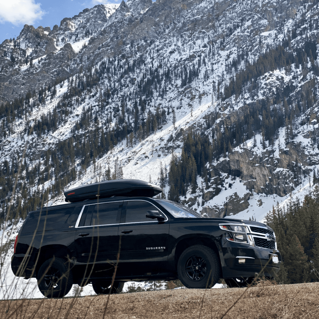 Private car service SUV traveling from Denver to a Colorado mountain town during early winter