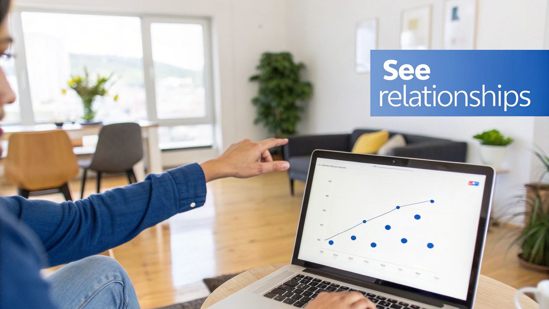 Person pointing at a laptop screen displaying a scatter plot, illustrating data relationships in a bright room.