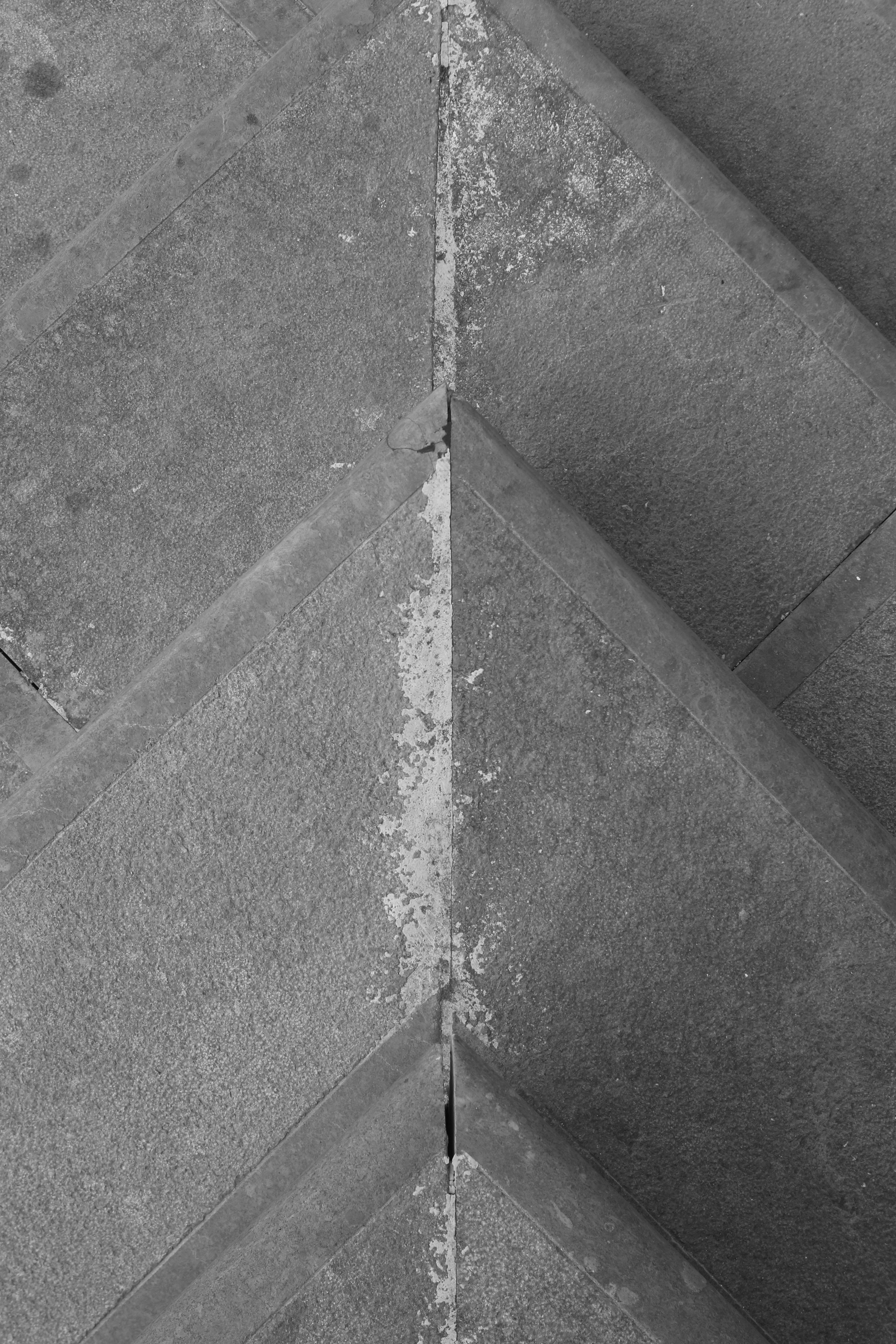 A black and white photo of a corner of concrete