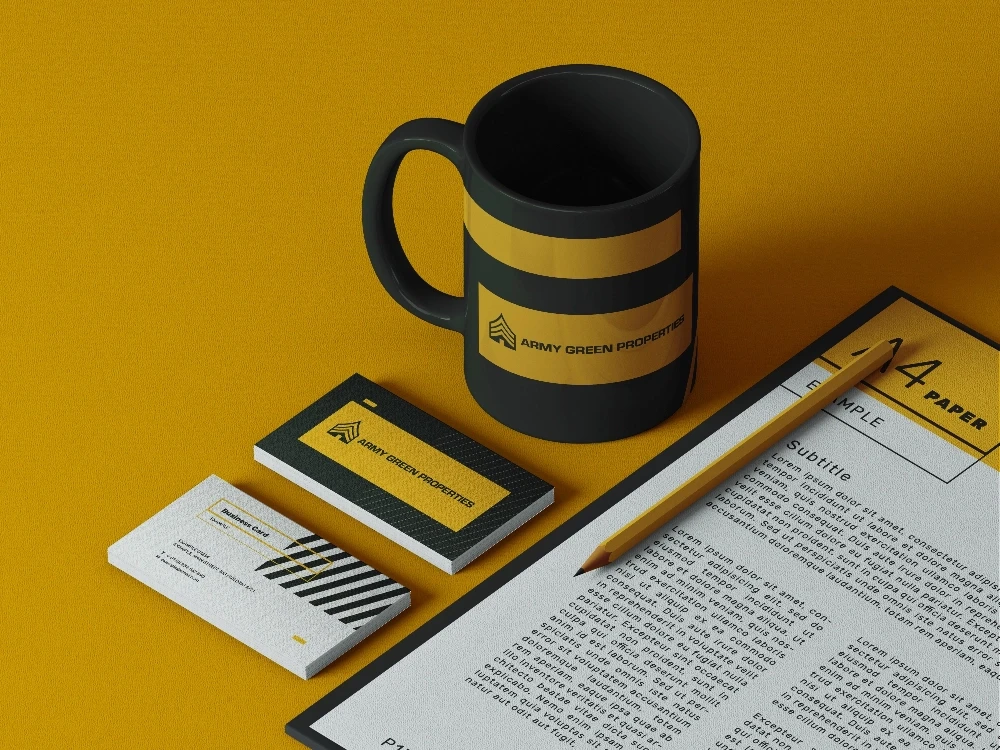 Mug with yellow stripes, business cards, and pencil on paper.
