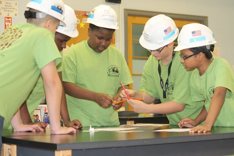 Students at BuffSci working on STEM project with safety gear