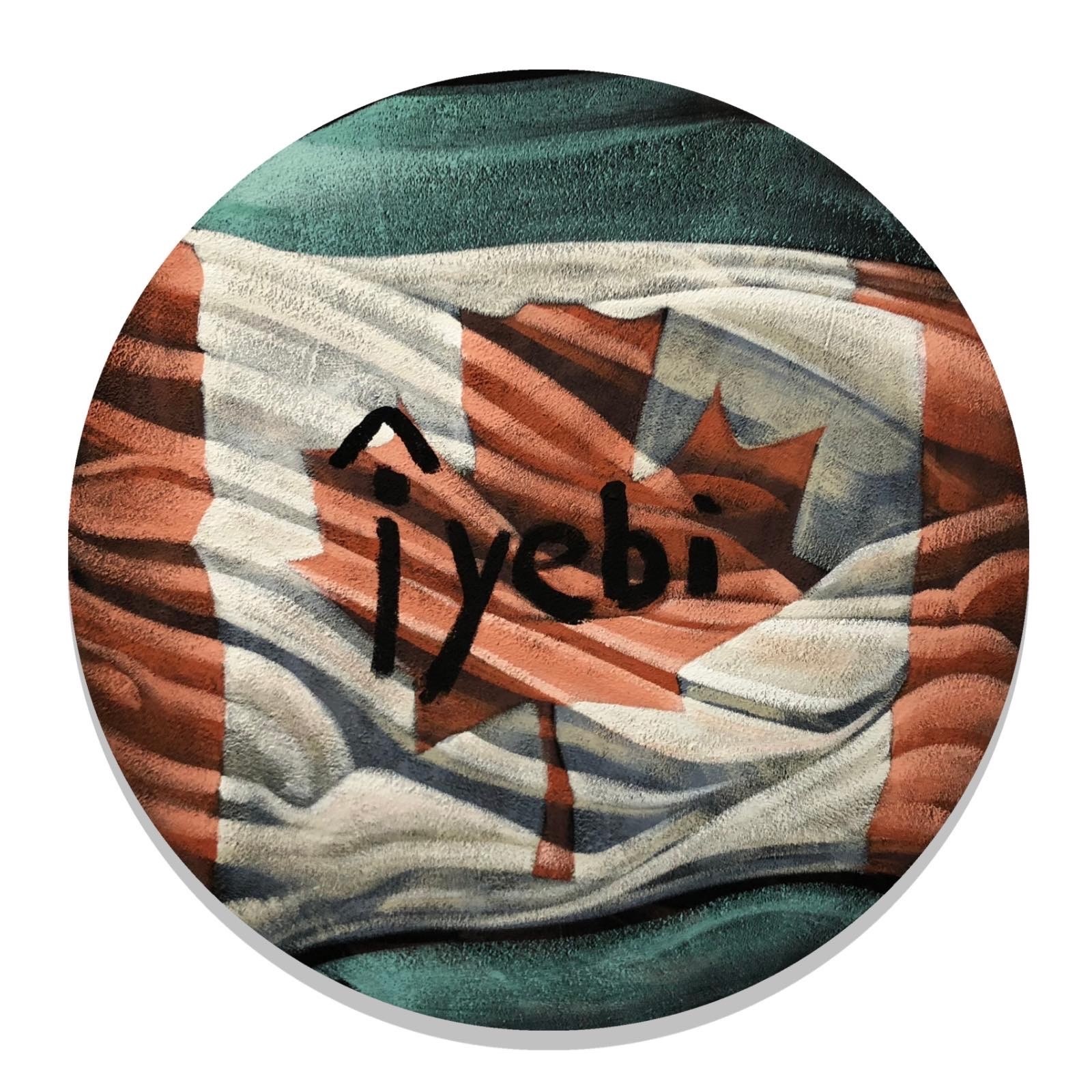 A round painting of a rippling Canadian flag with the word “Îyebi” written across it.
