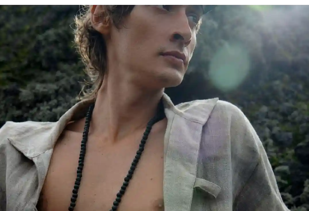 Male model showcasing Five and Diamond accessories with a grey blazer and black necklace