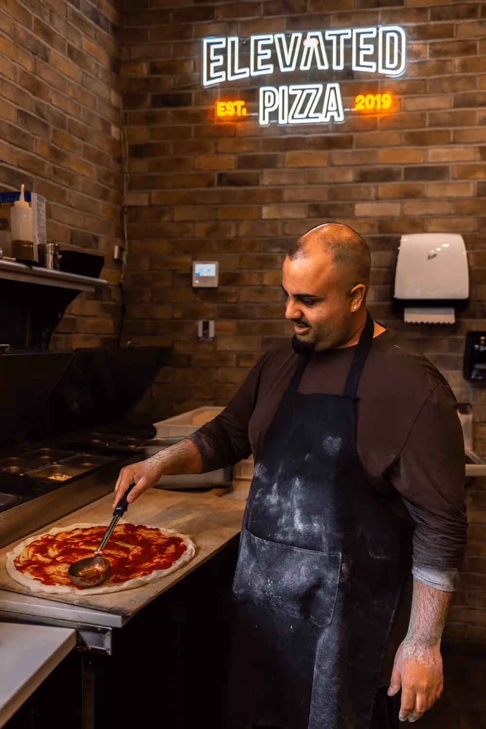 Elevated Pizza brand photography featuring people in a professional setting website showcase