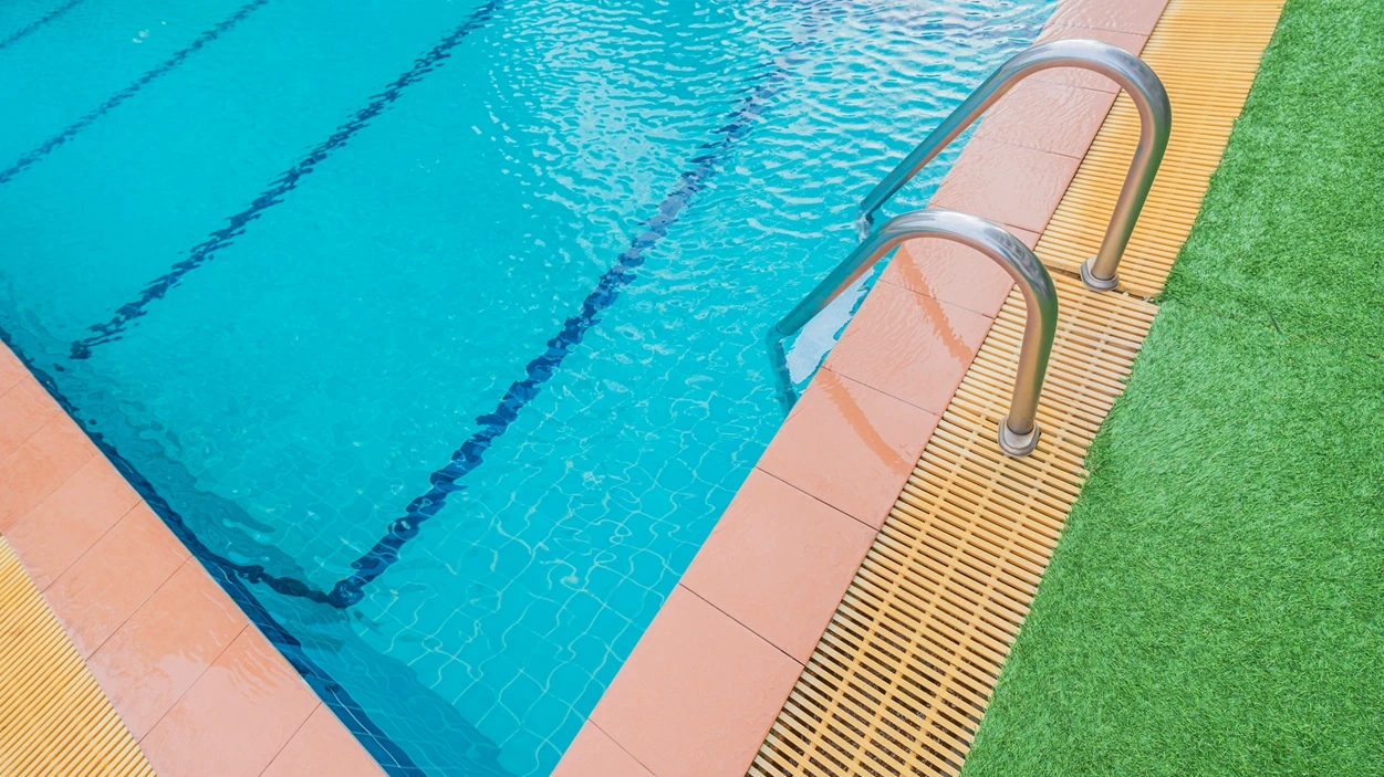 A clean commercial swimming pool with a handrail, representing premises liability and swimming pool injury representation by Schwinghamer Law in Stockton.