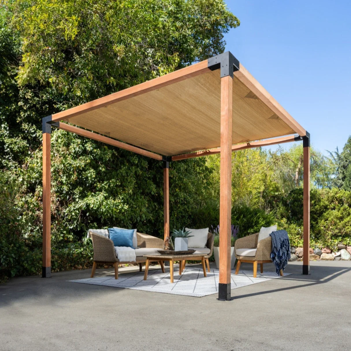 Flat-lay of curated material samples including stone tiles, textured fabrics, ceramics, and botanicals arranged on a neutral surface.