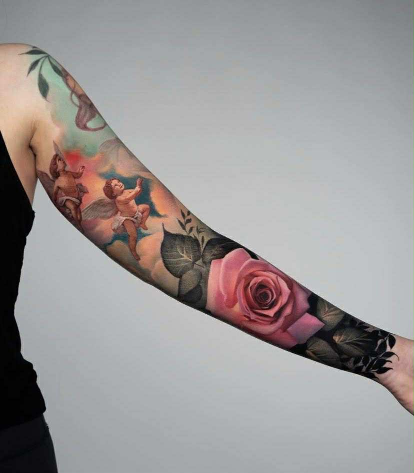 Full-arm tattoo combining hands, snakes, and geometric symbols.