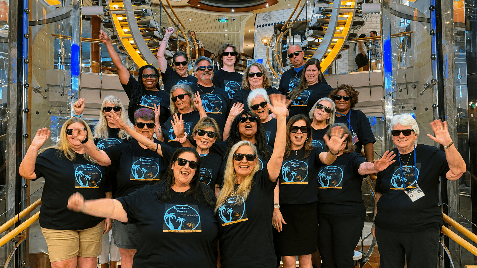 Shairose Gulamani with other Speakers on Influencers Cruise 2026, People in blue and yellow shirts posing for a photo.