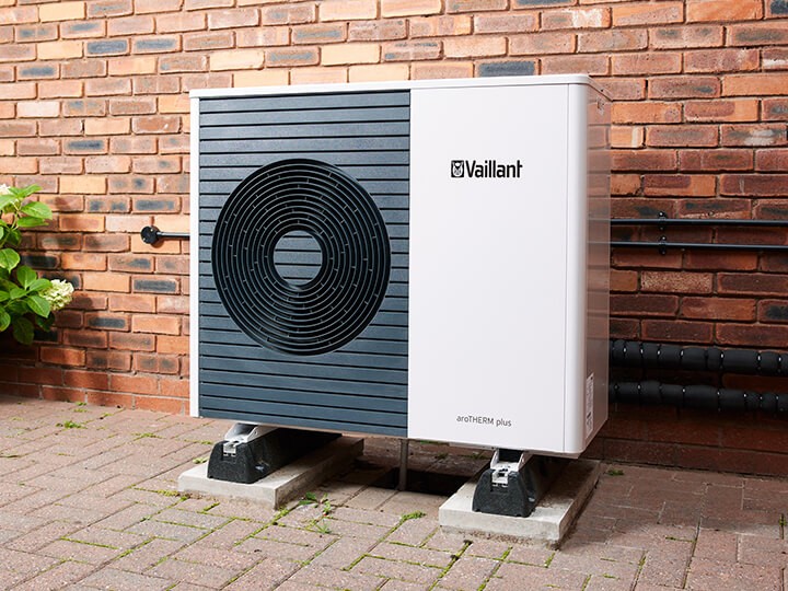 Air source heat pump installed outside a UK home showing how heat pump running costs compare to gas boilers in 2026
