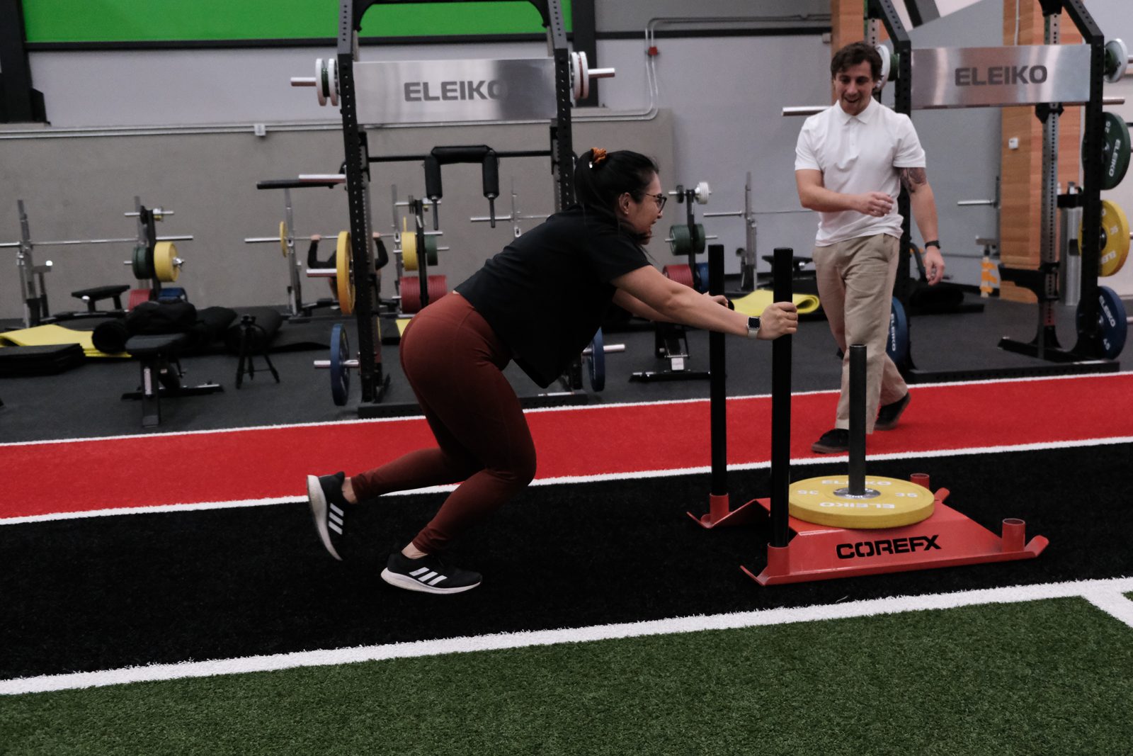 Sled push on the gym floor during rehab at Forza Physiotherapy