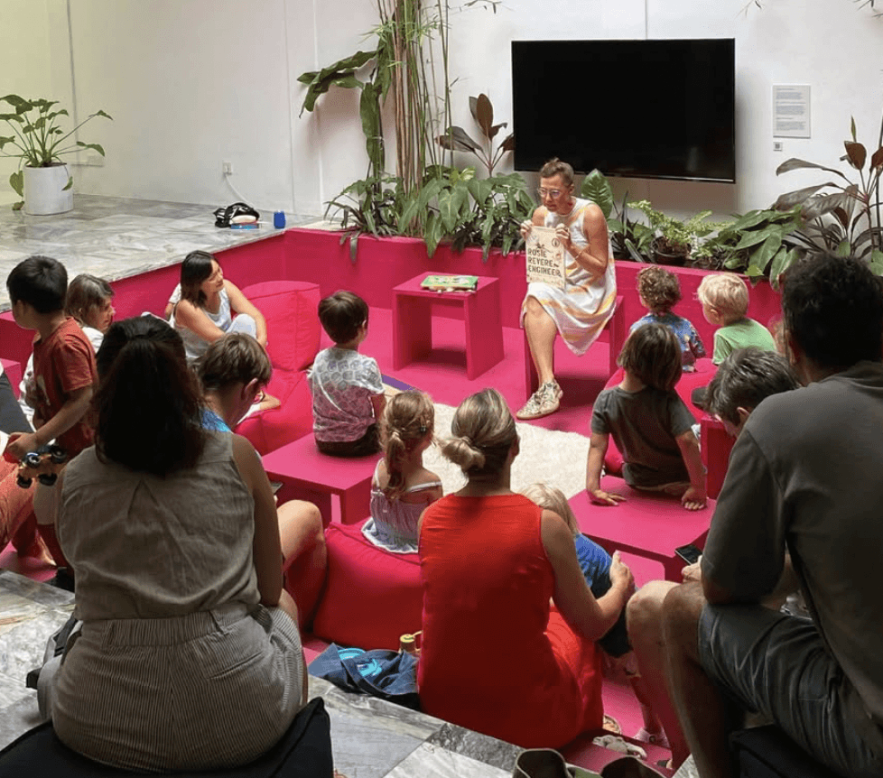 A man playing a drum in front of a group of people
