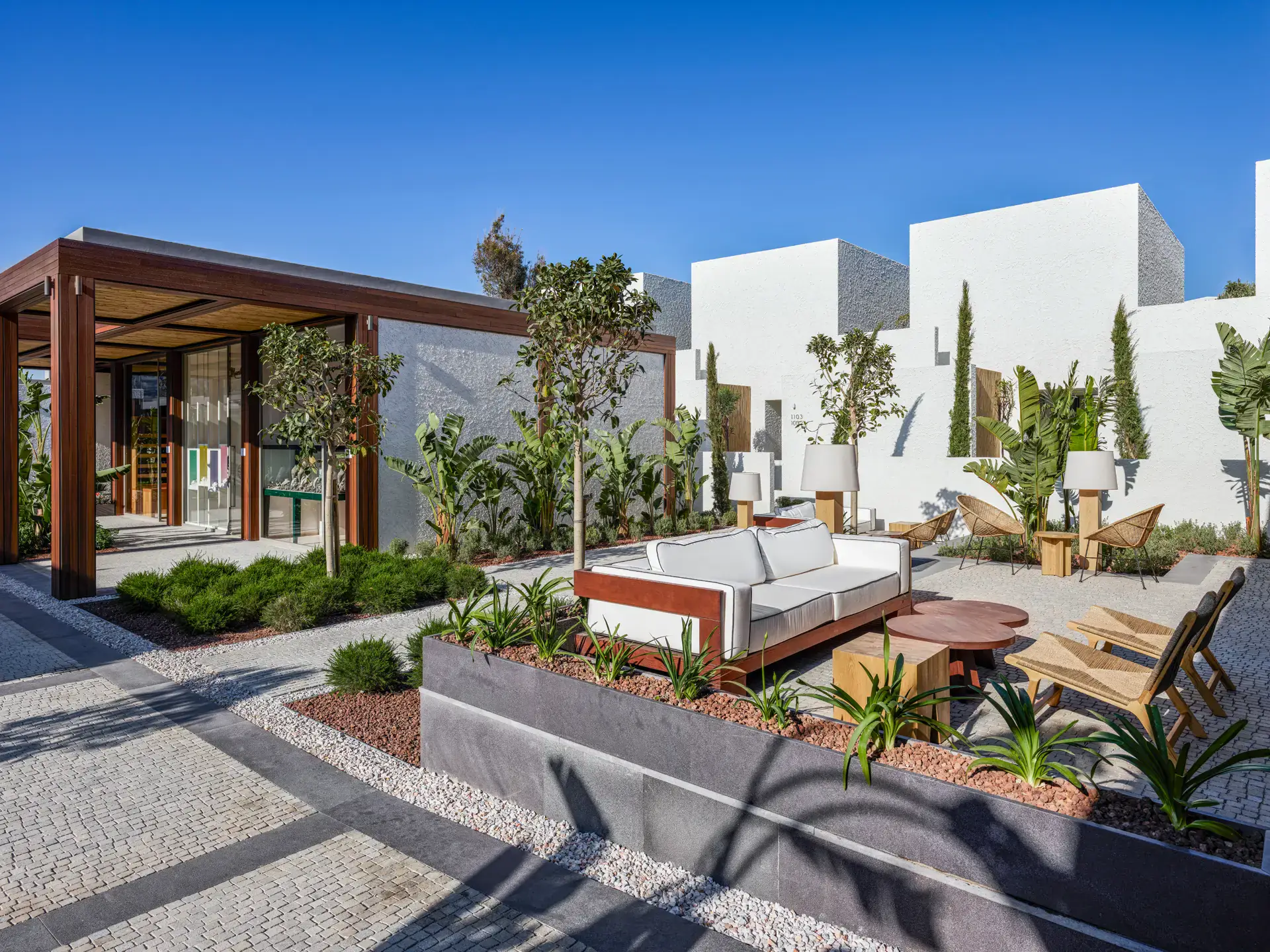Timber-framed building and seating area with white houses behind
