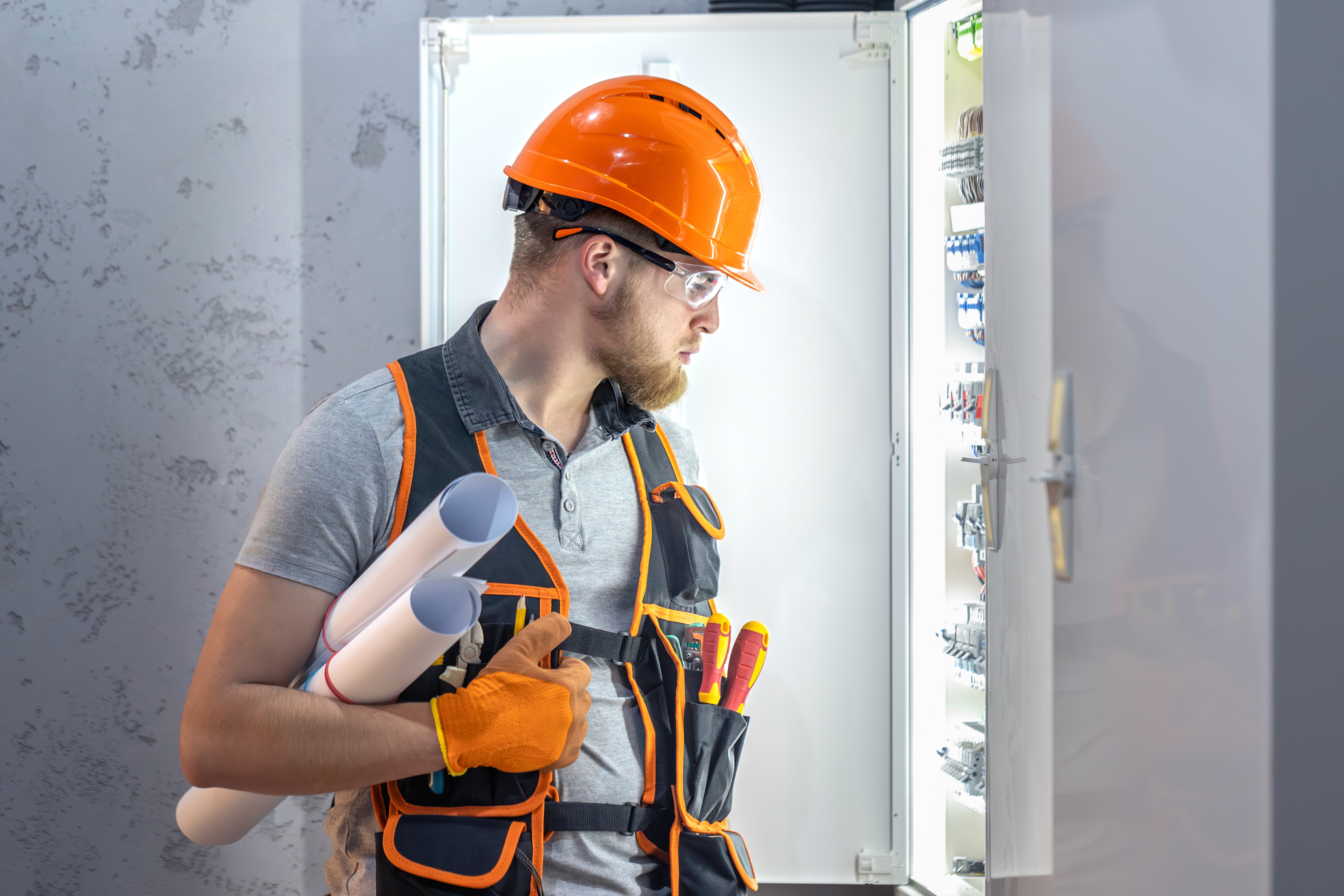 an electrician looking at wires