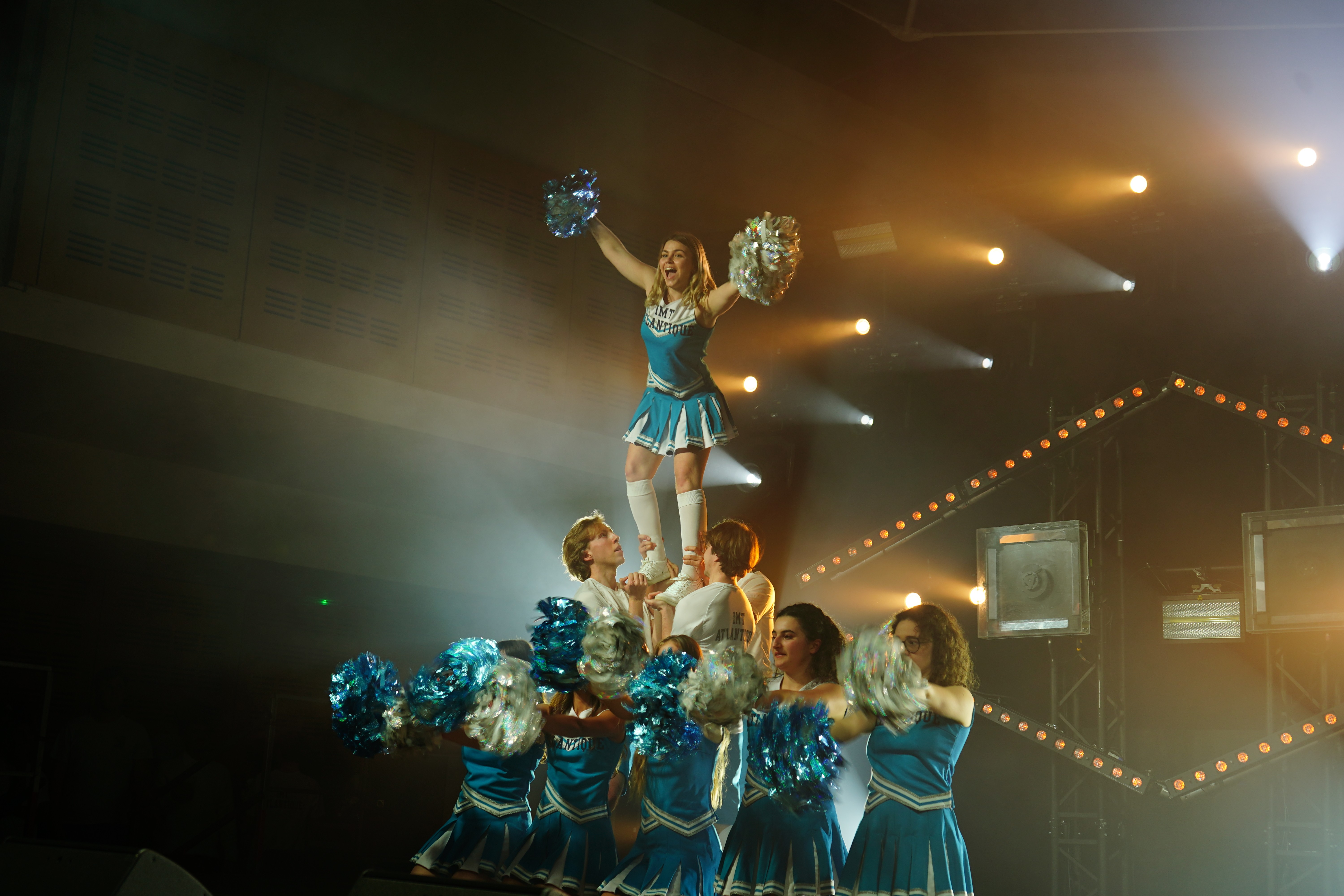Man walking down the stair with a motorcycle on top of the stairs.