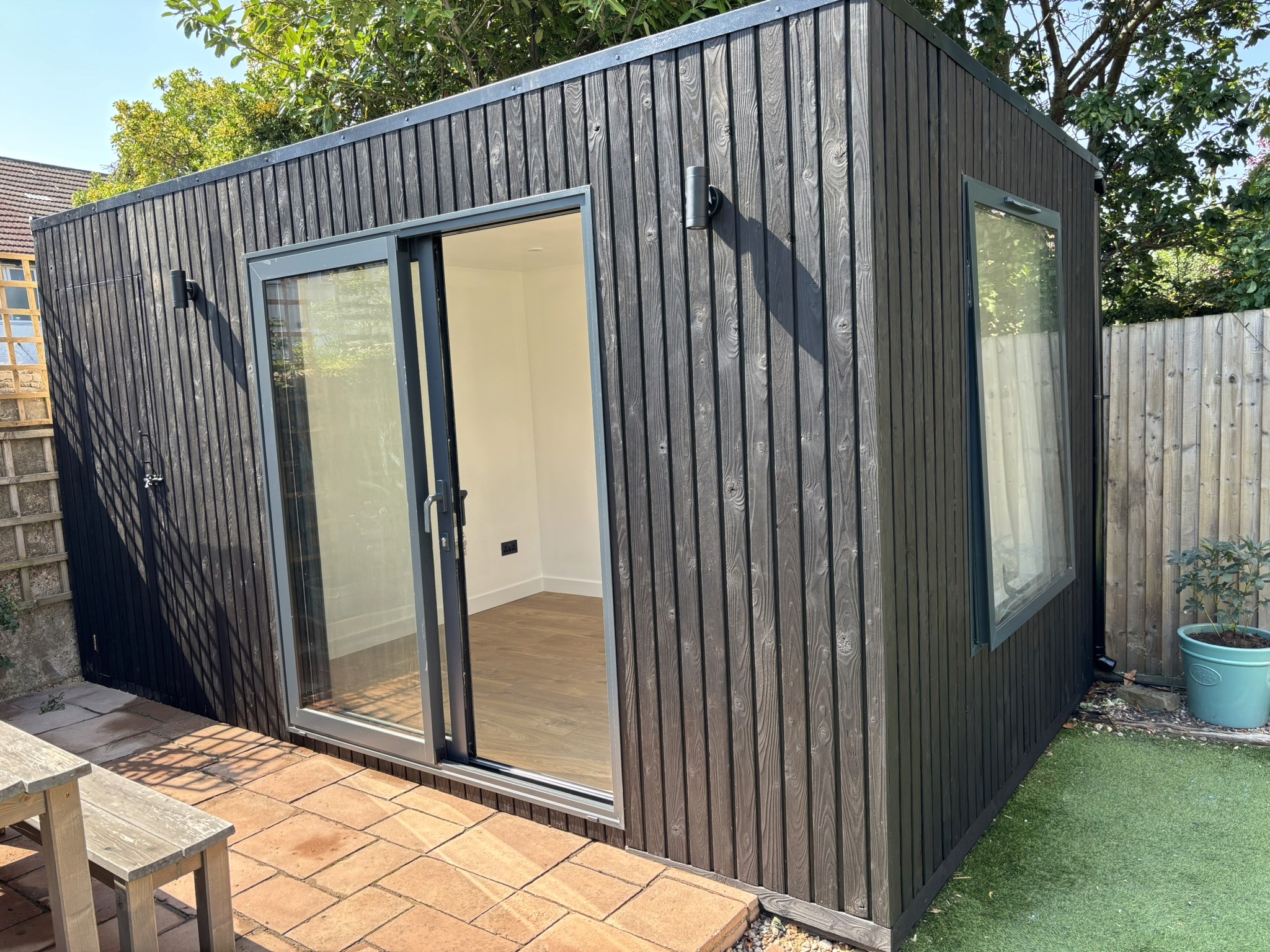 Kids Getaway Room in Streatham. Burnt Siberian larch garden room by Eleven Trees.