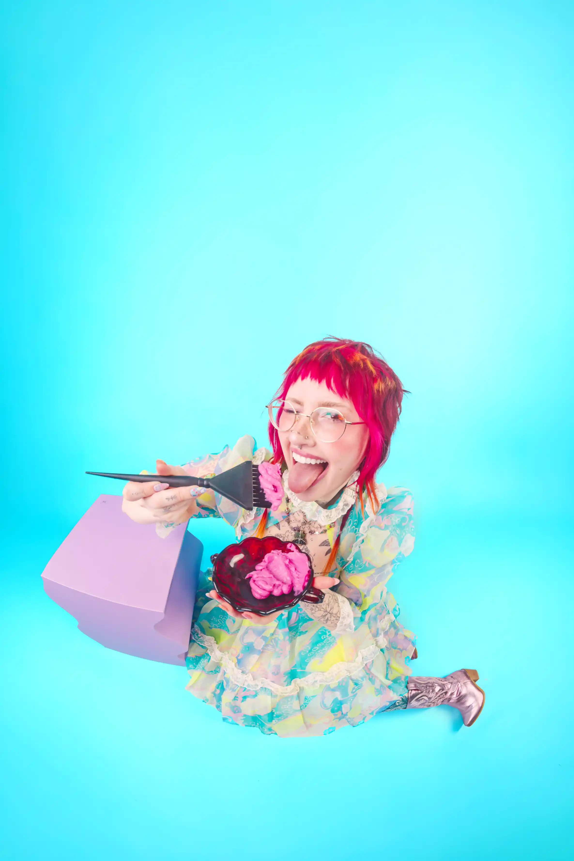 tampa hairstylist kayla  branding portrait on blue background eating hair color